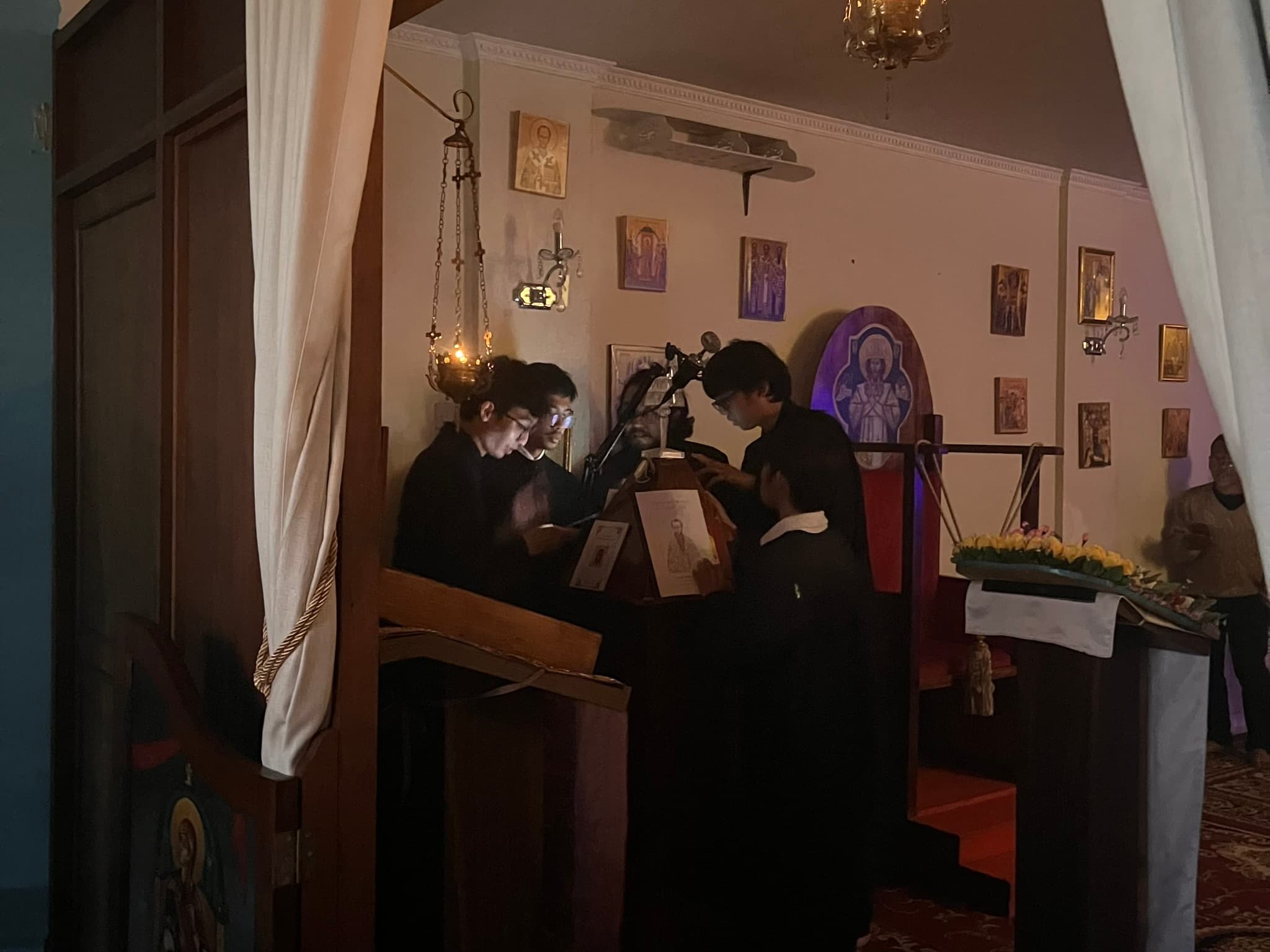atmospheric interior of an orthodox church with dim light and psaltis in the scene
