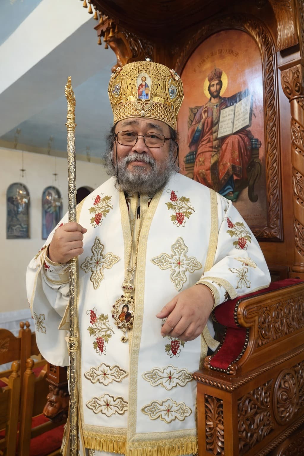 Dignified portrait of an Orthodox bishop in traditional liturgical vestments, holding a staff.